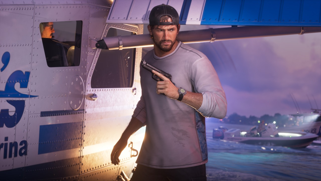 Jason beside a helicopter and patrol boat